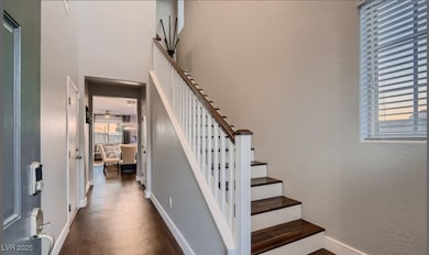 Stairway featuring wood finished floors and basebo