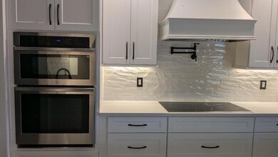 kitchen oven, microwave, range top and pot filler