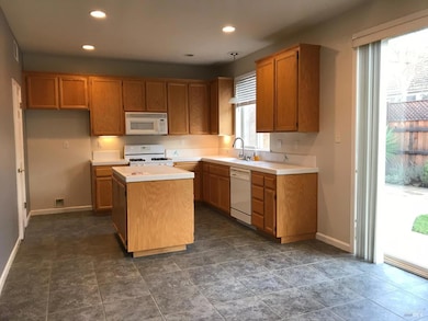Kitchen pantry tile floors, and entrance to back yard.  Family room - kitchen combo.