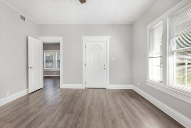 Spare room featuring ceiling fan and hardwood / wo