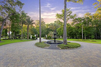 View of water fountain and brick paver circular drive features plenty of parking options when entertaining.
