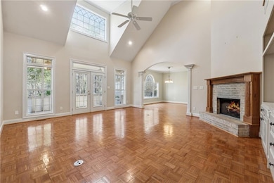 Unfurnished living room featuring ceiling fan with