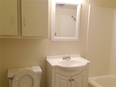 Full bath with toilet, vanity, and a bath