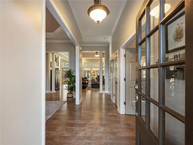 Corridor featuring crown molding and dark hardwood