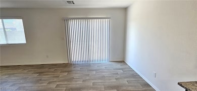Empty room featuring wood finished floors and baseboards