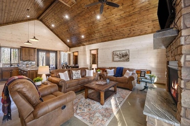 Living room with high vaulted ceiling and concrete