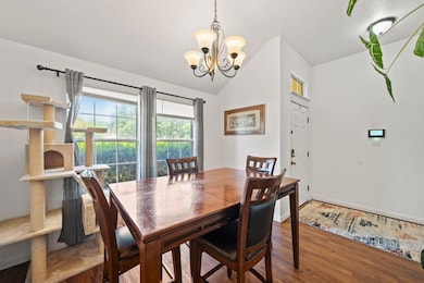 Dining room featuring a chandelier, vaulted ceili