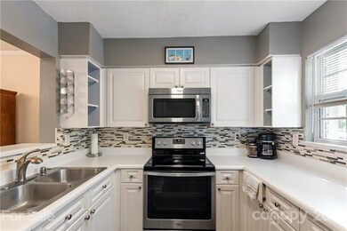 Spacious kitchen with glass tile backsplash