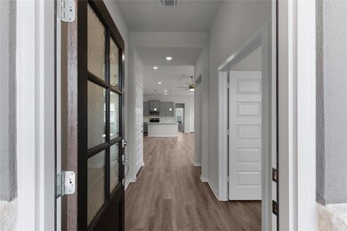 Hallway featuring dark wood finished floors and r