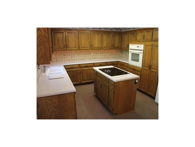Large island kitchen with solid surface counters a