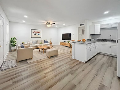 Experience the inviting warmth of this virtually staged great room, featuring elegant decor and an open layout perfect for modern living and entertaining.