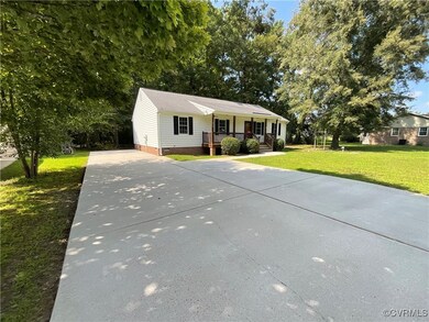 Ranch-style house with covered porch and a front lawn