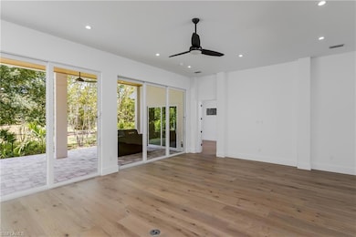 Unfurnished room with hardwood / wood-style floors, ceiling fan, recessed lighting, and baseboards