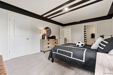 Bedroom featuring light carpet and radiator