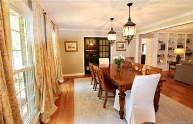 Gorgeous Formal Dining Room with lot of natural light, opens to the Great Room. The french doors lead into the Office.