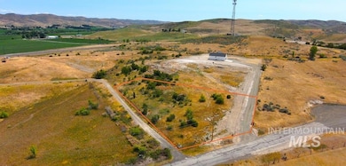 Overview of rural landscape featuring property boundaries highlighted and a mountain backdrop