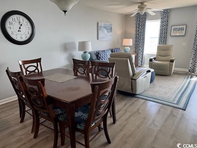 Dining room with light wood-style flooring and a ceiling fan
