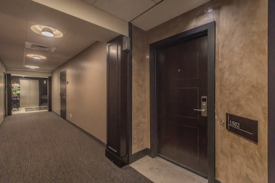 Hall with elevator and light marble finish flooring