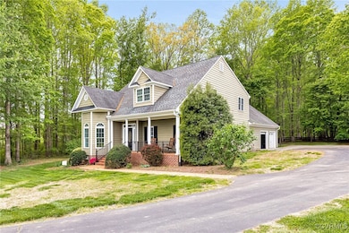 View of front of home with covered porch, driveway