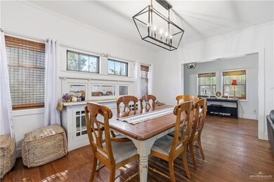 Dining room featuring crown molding, wood finished floors, and a chandelier