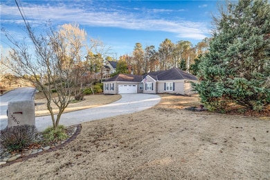 View of front facade featuring driveway and a garage