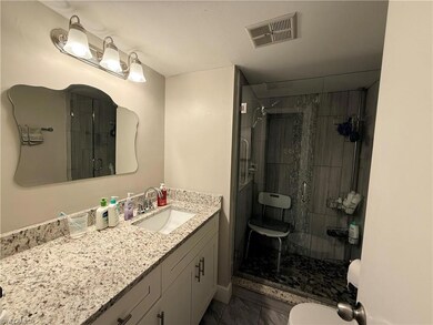 Full bath featuring vanity and a shower stall