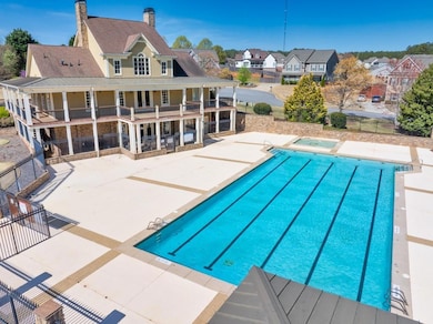 Pool with a hot tub, fence, a residential view, an