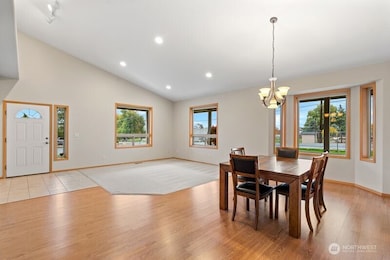 Large living room and dining room area with views out every window.