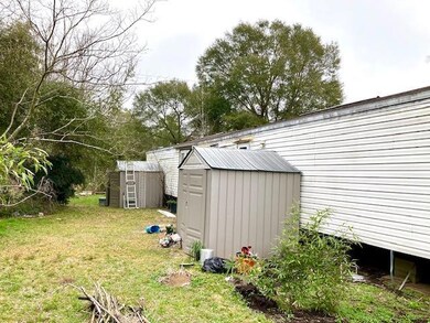 Sheds behind mobile home