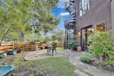 View of yard featuring a patio, stairs, and a bal