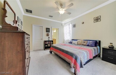 Bedroom with light carpet, crown molding, and a ce