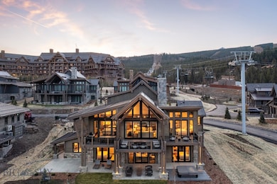 Back house at dusk with a balcony and a patio area