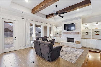 Living area with wood finished floors, visible ven