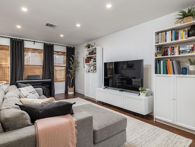 Living room featuring dark wood-style flooring an