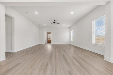 Unfurnished living room with ceiling fan, recessed