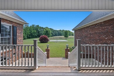Covered porch in back overlooking an open patio ar