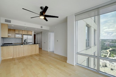 Kitchen featuring high end fridge, dark counterto