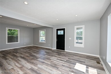 Foyer with plenty of natural light, recessed lighting, and wood finished floors