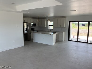 Kitchen with stainless steel appliances, a sink, p