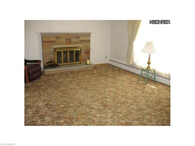 Alternate view of living room shows wood burning f