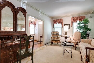 Sunny living room with mirrored wall that reflects