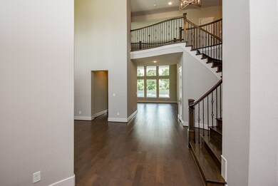 Enter the home and find high ceilings and a fromal dining area.