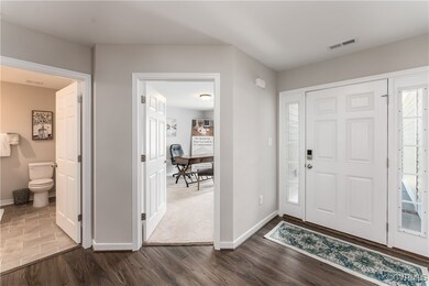 Entrance foyer with dark hardwood / wood-style flo