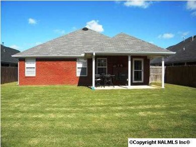 Back of home, covered patio. You can access the backyard via the living room