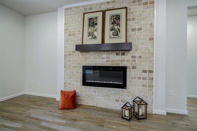 Living room featuring a fireplace and hardwood / wood-style tile plank floors