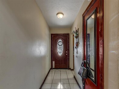 Doorway featuring light tile flooring