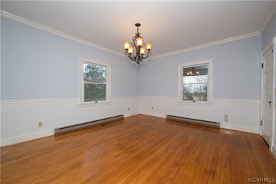 The formal dining room has stunning wood floors, c