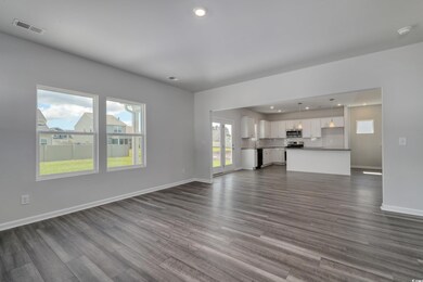 Unfurnished living room with recessed lighting, ba