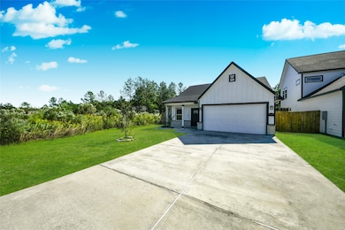 Focuses on the expansive concrete driveway and the large two-car garage door. Note the generous setback from the street.