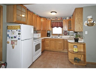 Updated kitchen with oak cabinets and ceramic tile
